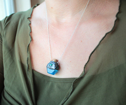 Witchy blue potion necklace with a miniature glass bottle and bronze details