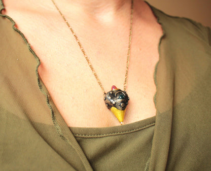 Handmade forest inspired pendant with a green gemstone and bronze finish