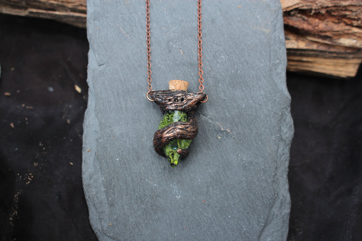 Nature-inspired potion bottle necklace with handcrafted tree branch details