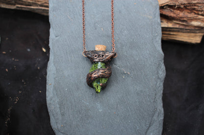 Nature-inspired potion bottle necklace with handcrafted tree branch details