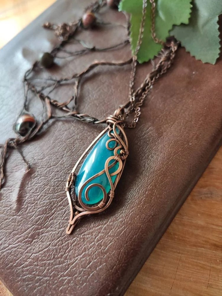 Close up of blue agate gemstone necklace with fantasy inspired design