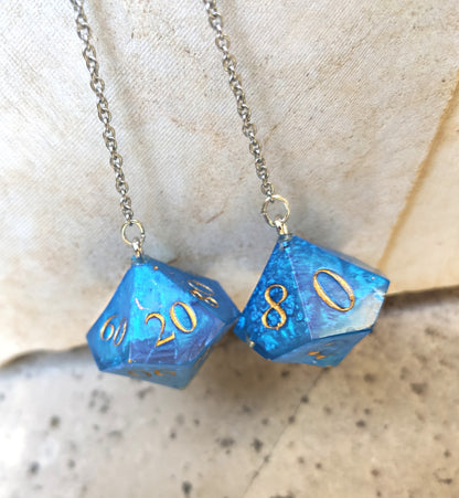 Detailed shot of blue D10 dice earrings, handcrafted resin and stainless steel