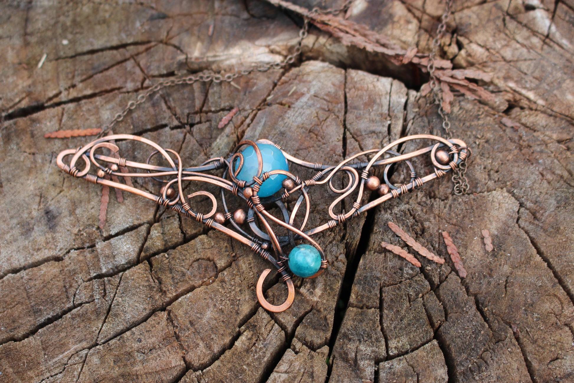 Close up detail of copper wire wrapped fantasy amulet necklace