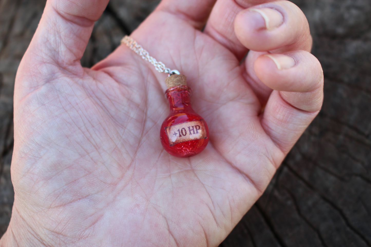 HP Healing Potion necklace in hand, perfect magical gift for fantasy enthusiasts
