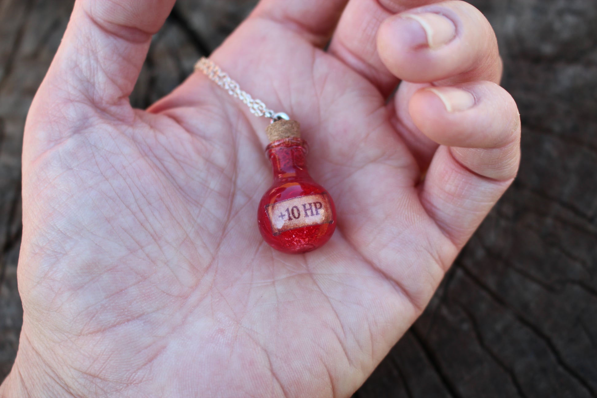 HP Healing Potion necklace in hand, perfect magical gift for fantasy enthusiasts
